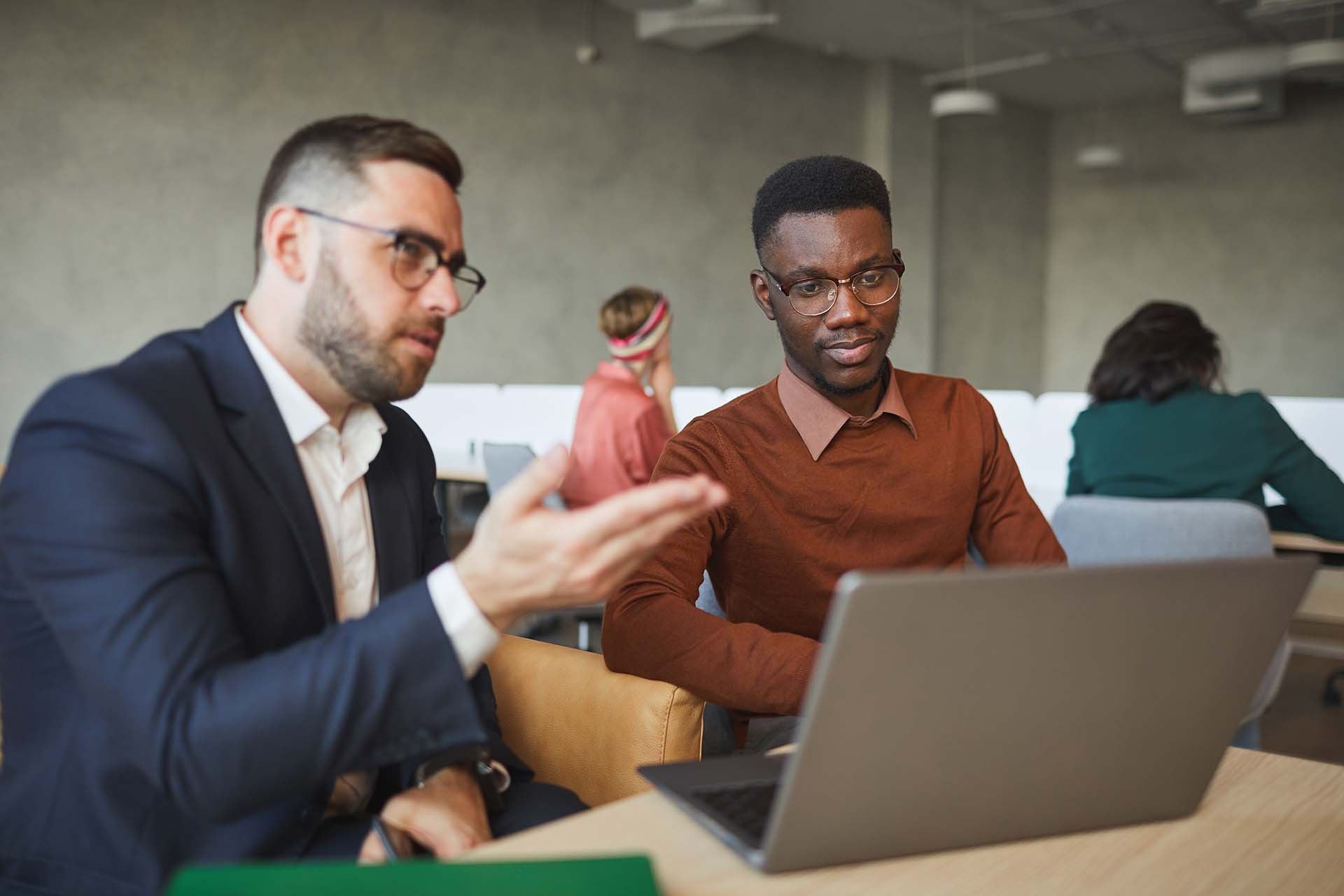 Boss Instructing Employee in Office